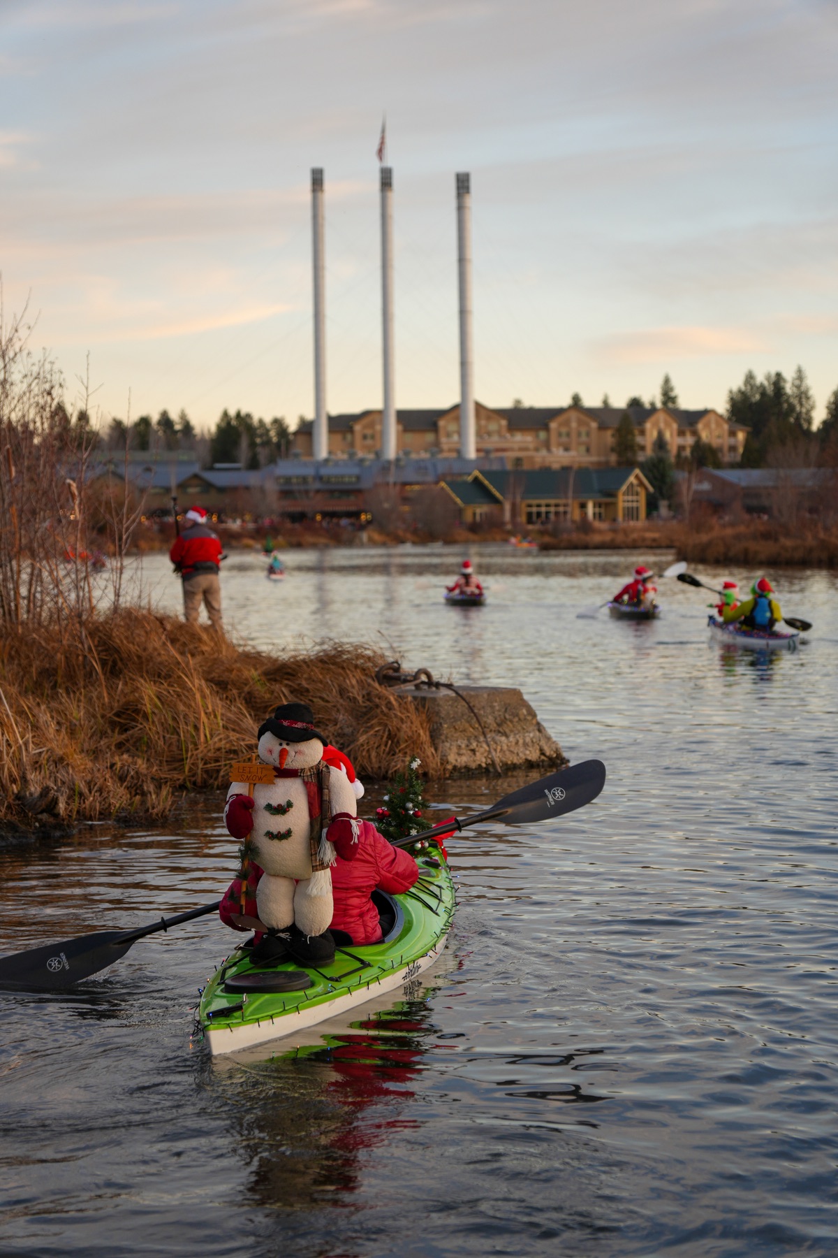 Christmas paddle flotilla glowing on the river