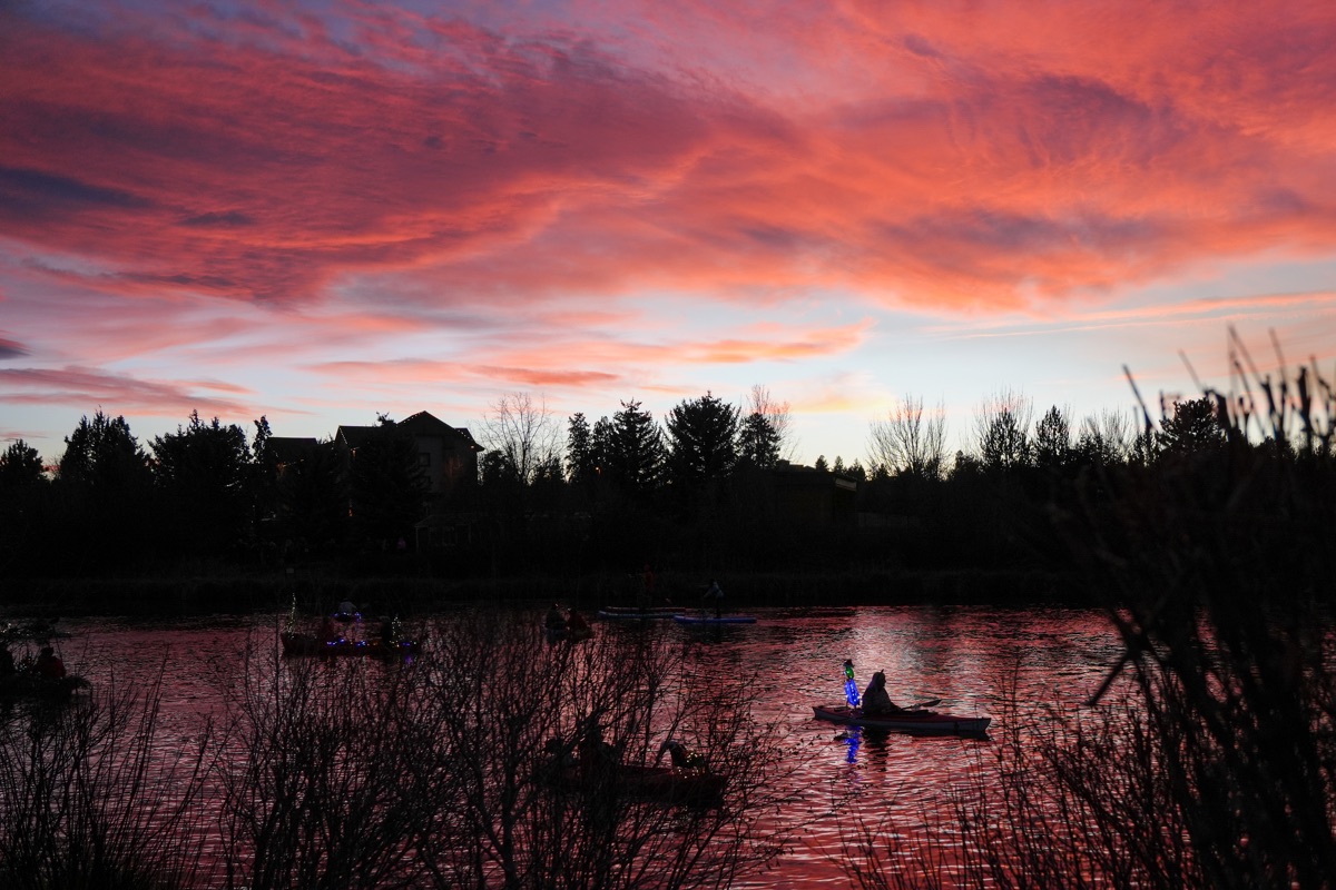 Holiday paddlers in costume carrying lights